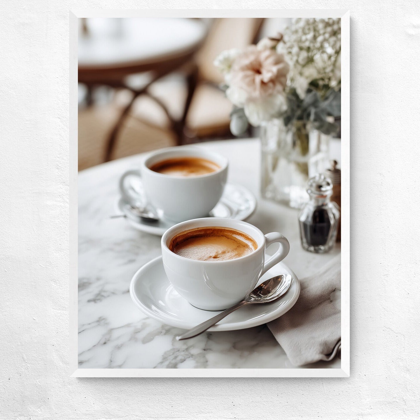 Two cups of coffee on a marble table with a blurred background
